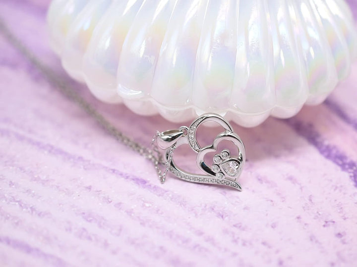 Sterling silver necklace with paw print and hearts, set with zirconia.