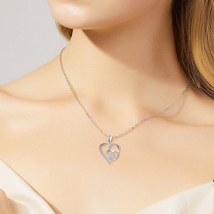 Sterling silver necklace with paw print and hearts, set with zirconia.