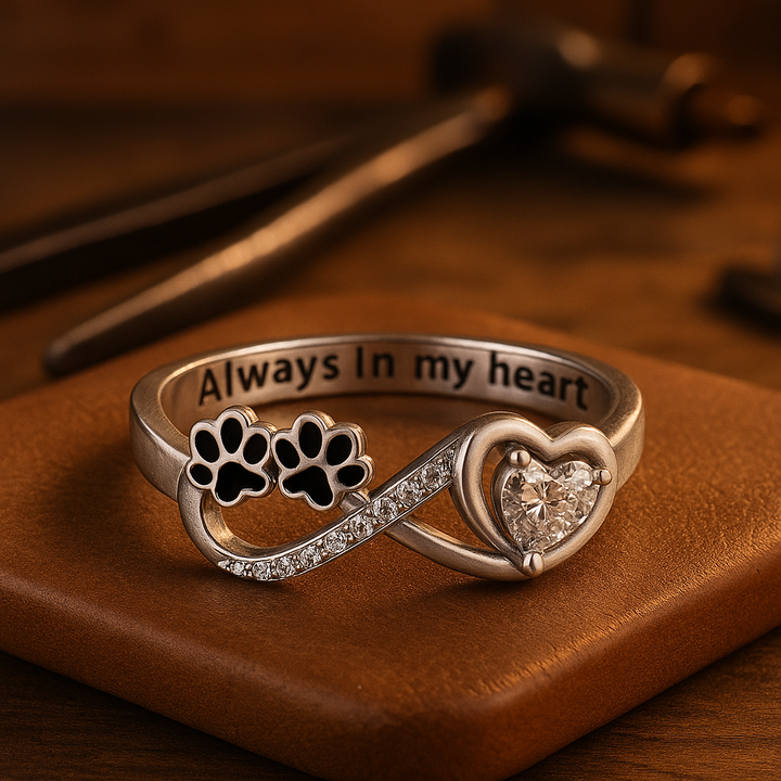 Ring with paw-shaped zirconia stones, heart and infinity symbol.