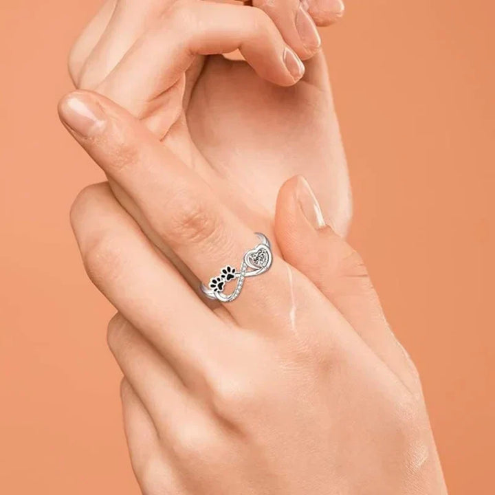 Ring with paw-shaped zirconia stones, heart and infinity symbol.