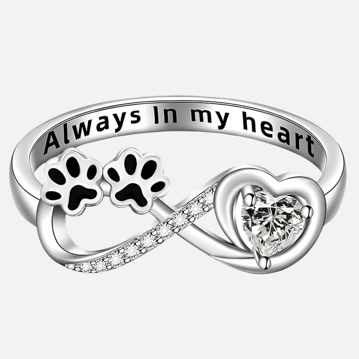 Ring with paw-shaped zirconia stones, heart and infinity symbol.