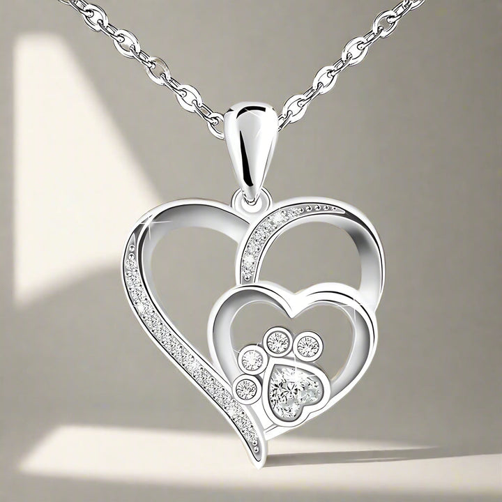 Sterling silver necklace with paw print and hearts, set with zirconia.